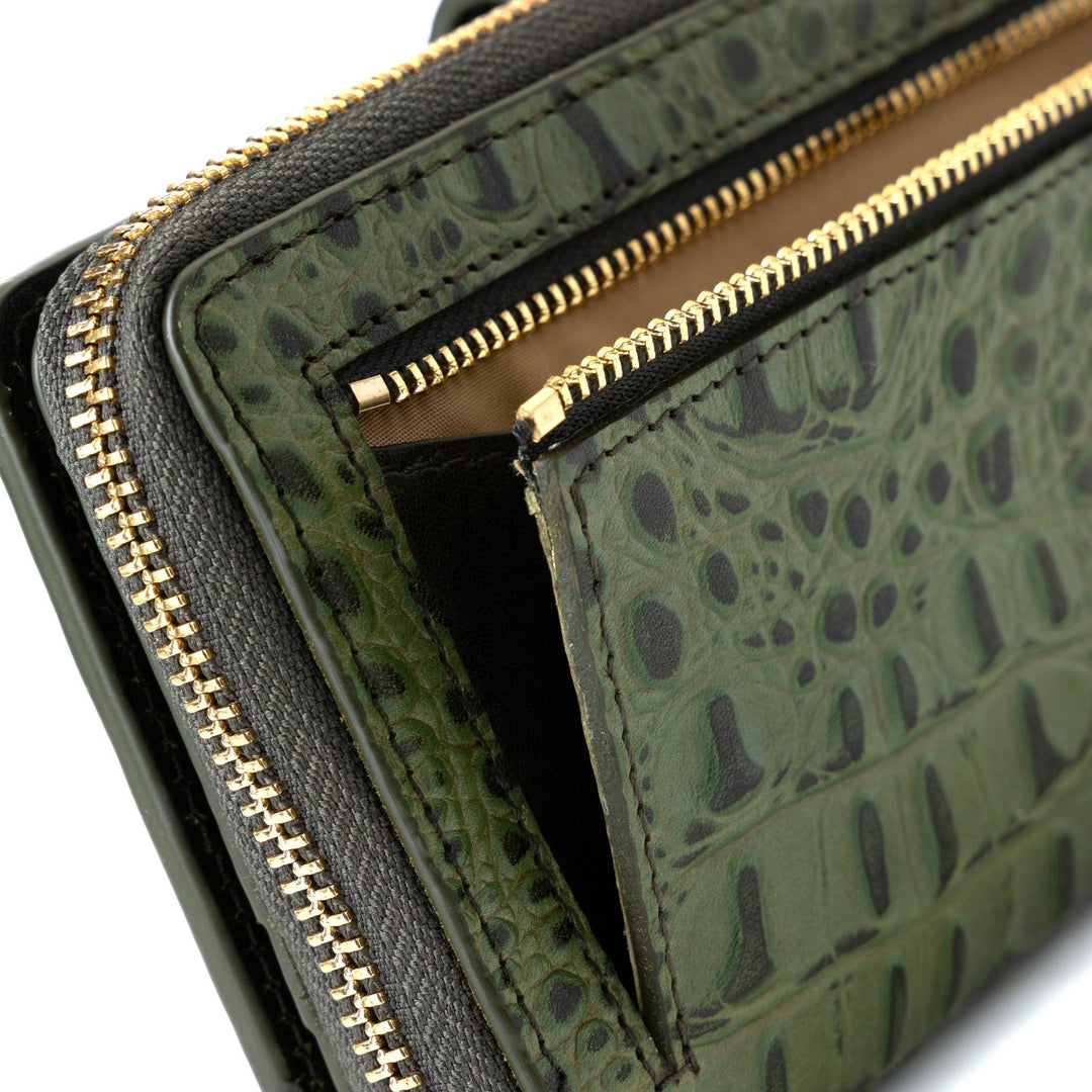 Back view of women’s green croc-embossed leather travel wallet with dual zip compartments and gold hardware