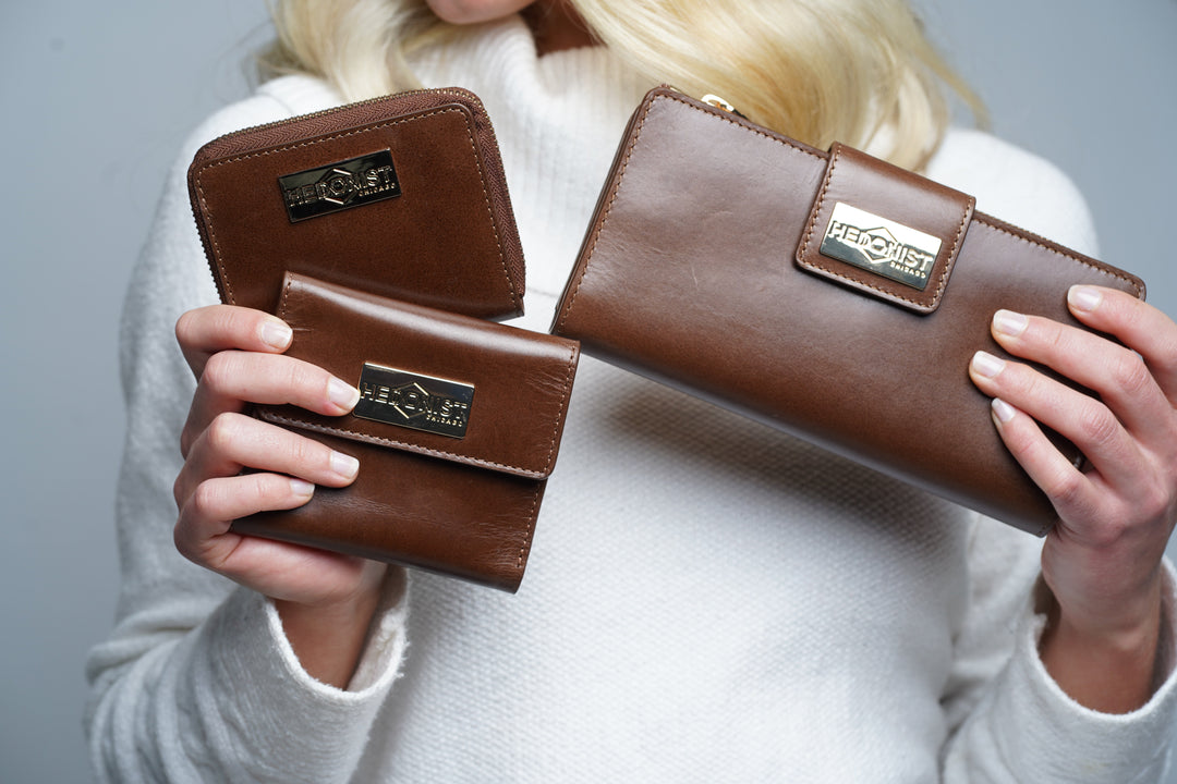 Trifold wallet for women in brown leather with coin pocket, multiple card slots, and compact three-fold design