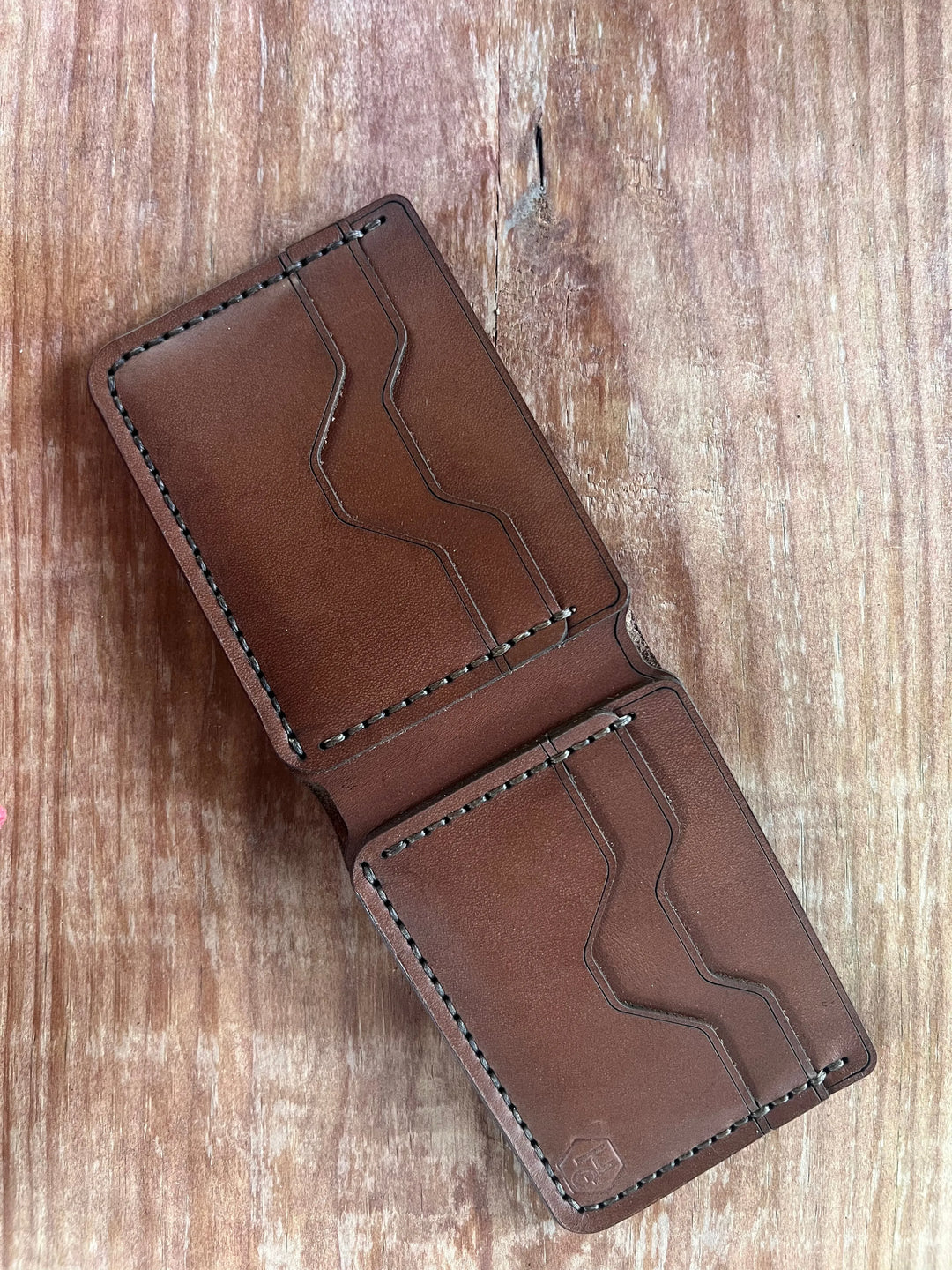 Handmade leather wallet showing hand-stitched construction with multiple card pockets and full grain leather for daily use