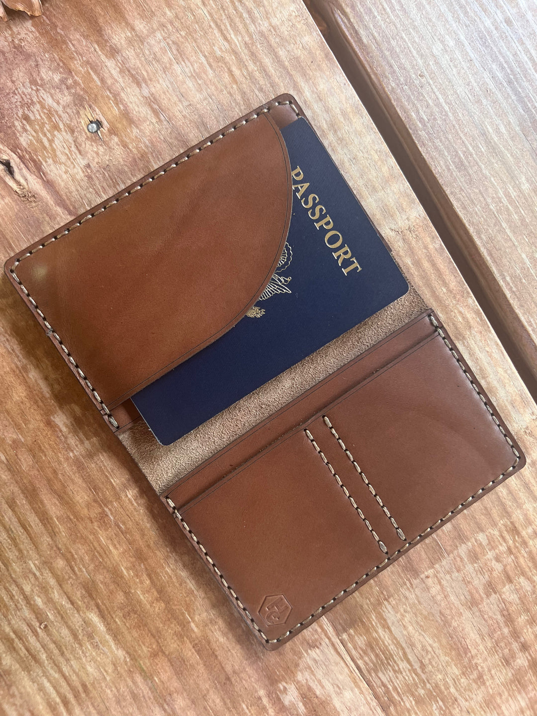 Handmade leather passport case showing hand-stitched construction with document protection and full grain leather for travel use