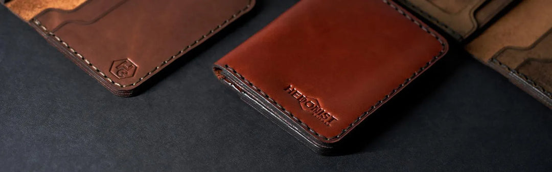 Handmade leather passport cases showing hand-stitched construction with protective thickness for travel document storage