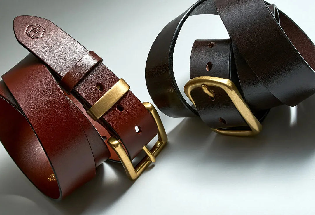 Full grain leather belts with various buckle mechanisms showing quality construction and durable stitching