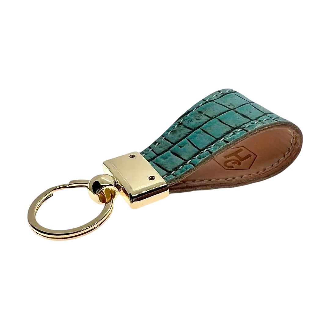 Handmade leather key chains showing hand-stitched construction with brass hardware and reinforced attachment points
