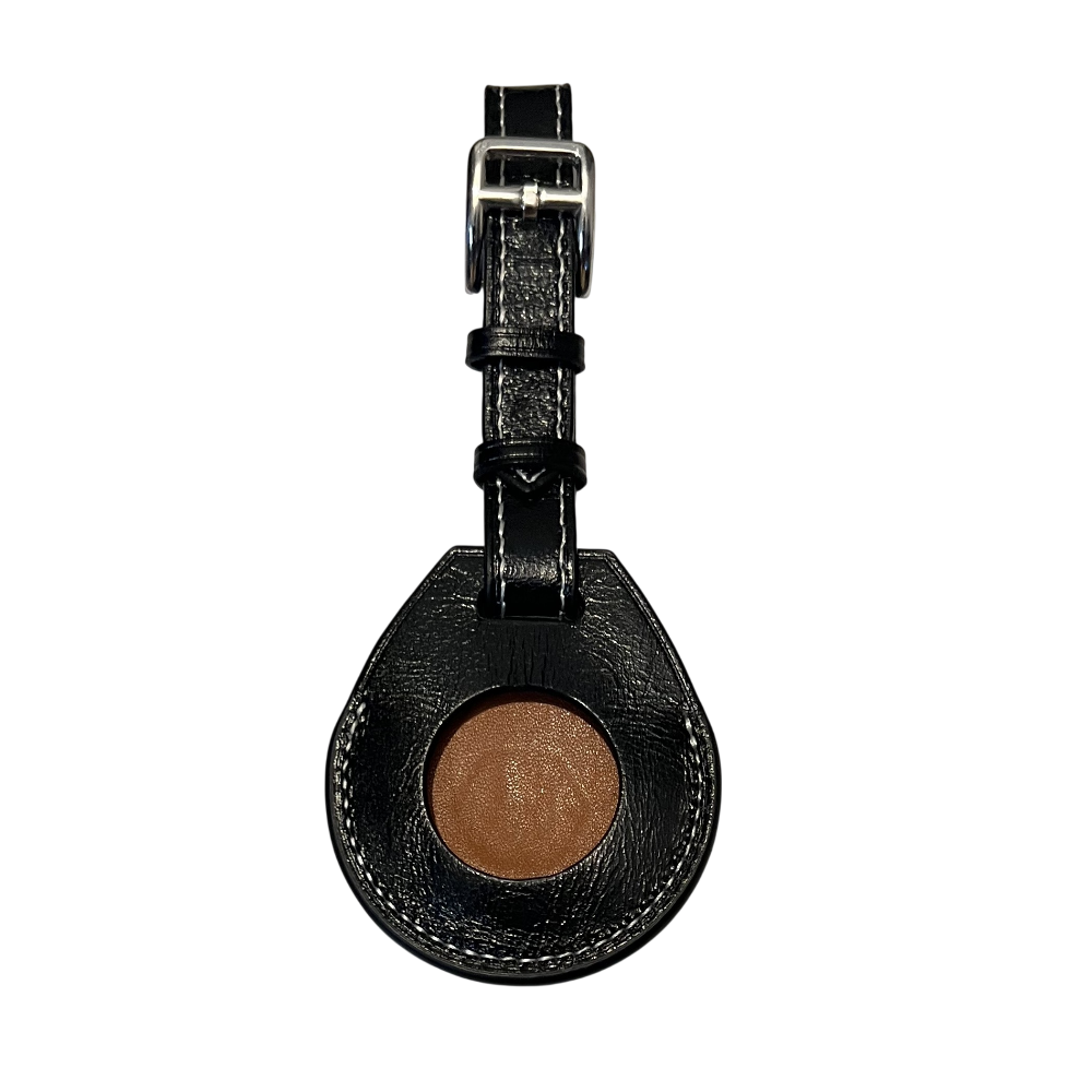 A teardrop-shaped black leather AirTag Holder attached to a black strap with a silver buckle