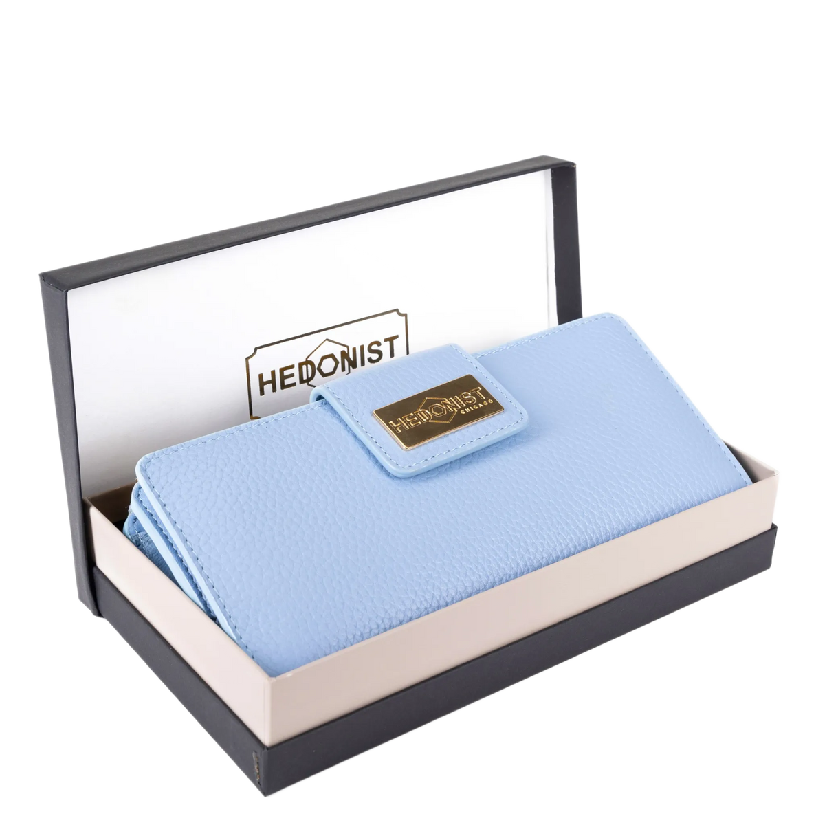 A light blue pebbled leather wallet with a gold-tone 'HEDONIST' logo plaque, presented inside an open two-tone black and beige gift box. The brand name 'HEDONIST' is also visible on the inner lid insert.