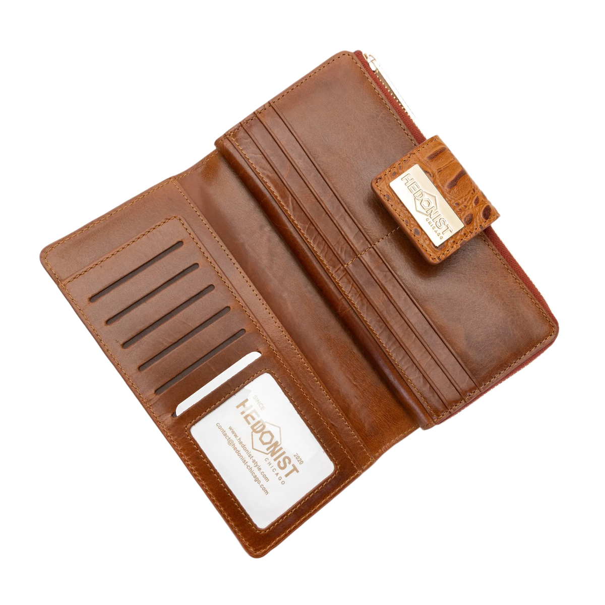 A brown leather wallet shown open, displaying its interior card slots, bill compartment, and a zippered pocket. The brand name 'HEDONIST CHICAGO' is visible on a small leather tag and a white card insert.