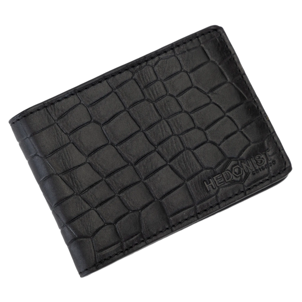 Black crocodile-embossed leather bifold wallet with a debossed HEDONIST logo on the lower right corner, shown on a plain white background.