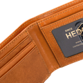 Close-up of an open tan leather wallet showing card slots, stitching, and a black brand patch.