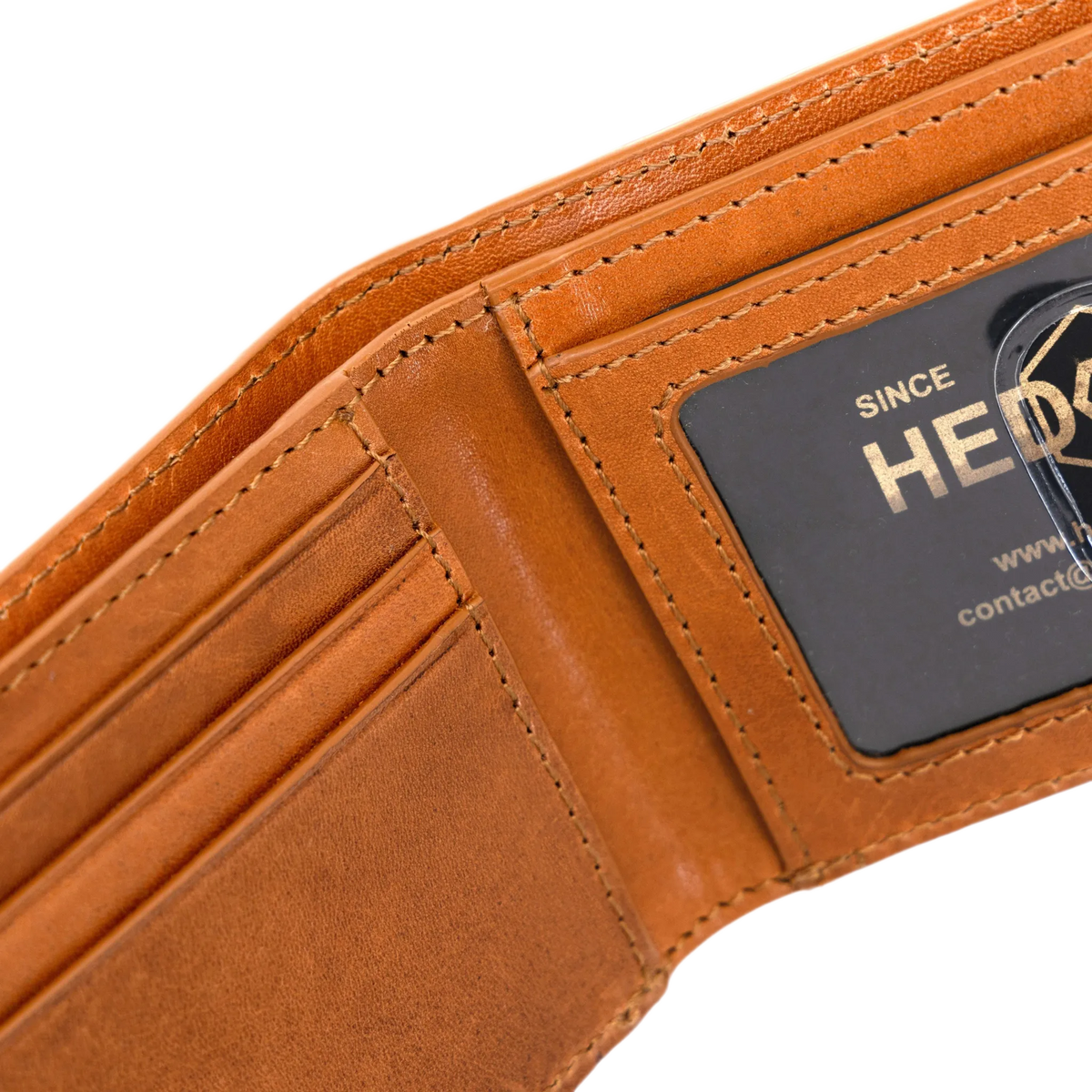 Close-up of an open tan leather wallet showing card slots, stitching, and a black brand patch.