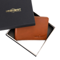 A brown leather wallet by Hedonist Chicago, displayed inside its open black presentation box with a matching lid, on a white background.