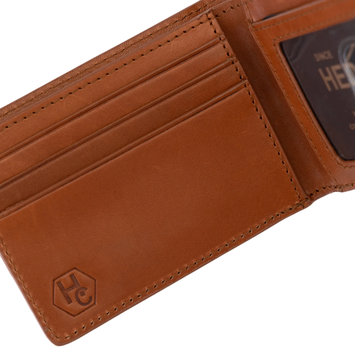 A close-up of an open brown leather wallet showing card slots, a cardholder pocket, and a debossed logo on the lower left corner.