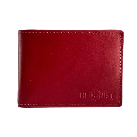 A red leather bifold wallet with visible stitching and an embossed logo reading 'HEDONIST Chicago' on the lower right.