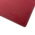 A close-up of a red leather wallet corner with matching red stitching and an embossed logo reading 'HEDONIST CHICAGO' on a white background.