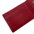 A close-up of a red leather cardholder wallet showing the interior card slots, stitching, and an embossed logo on a white background.
