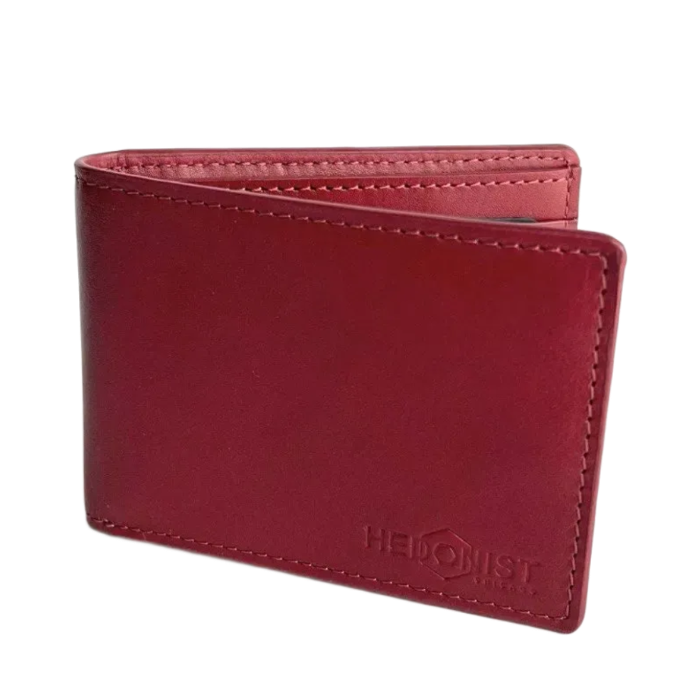 A red leather bi-fold wallet with a debossed Hedonist logo on the front, shown on a plain white background.