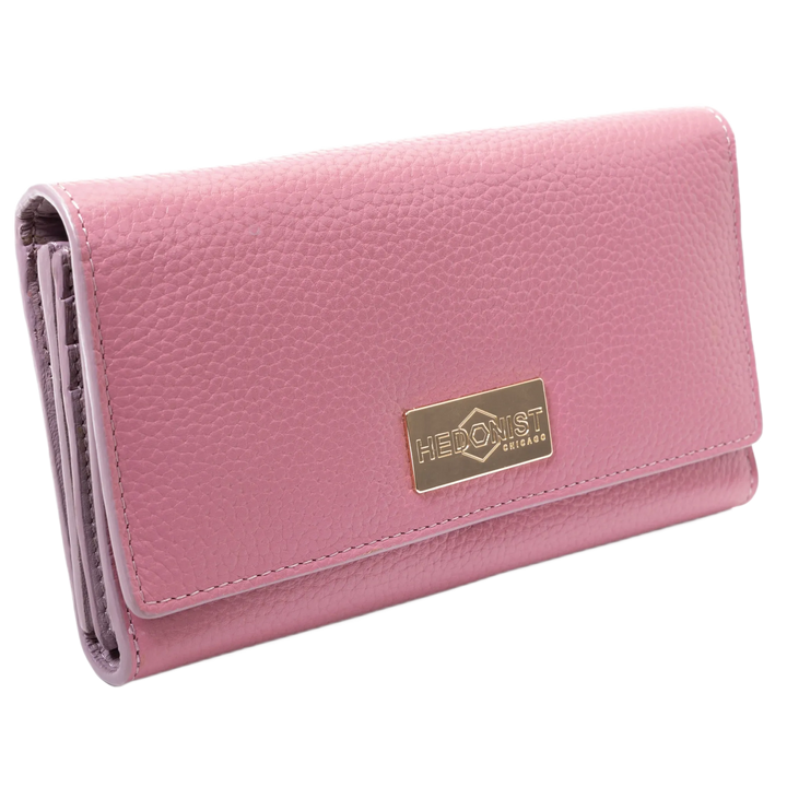 Pink leather trifold wallet for women closed, gold-tone Hedonist Chicago plaque on front