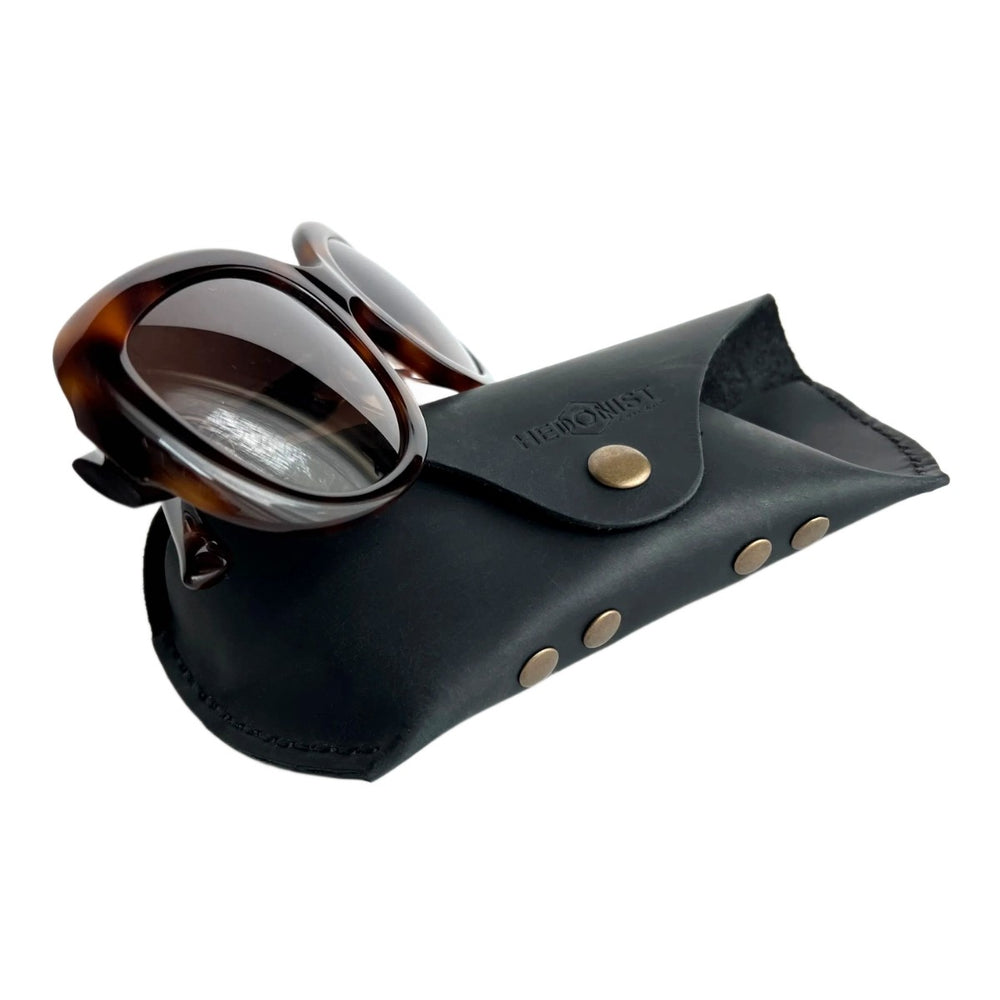 Soft Leather Eye Glasses Case in Black with tortoiseshell sunglasses leaning against it