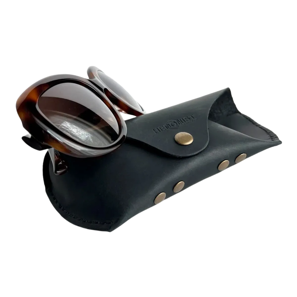Soft Leather Eye Glasses Case in Black with tortoiseshell sunglasses leaning against it