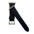Black leather Apple Watch band, texture and buckle detail close-up