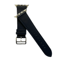 Black leather Apple Watch band, texture and buckle detail close-up