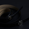 Side view on women's reversible design leather belt - black - Hedonist Chicago - close-up view (1", reversible with ivory)