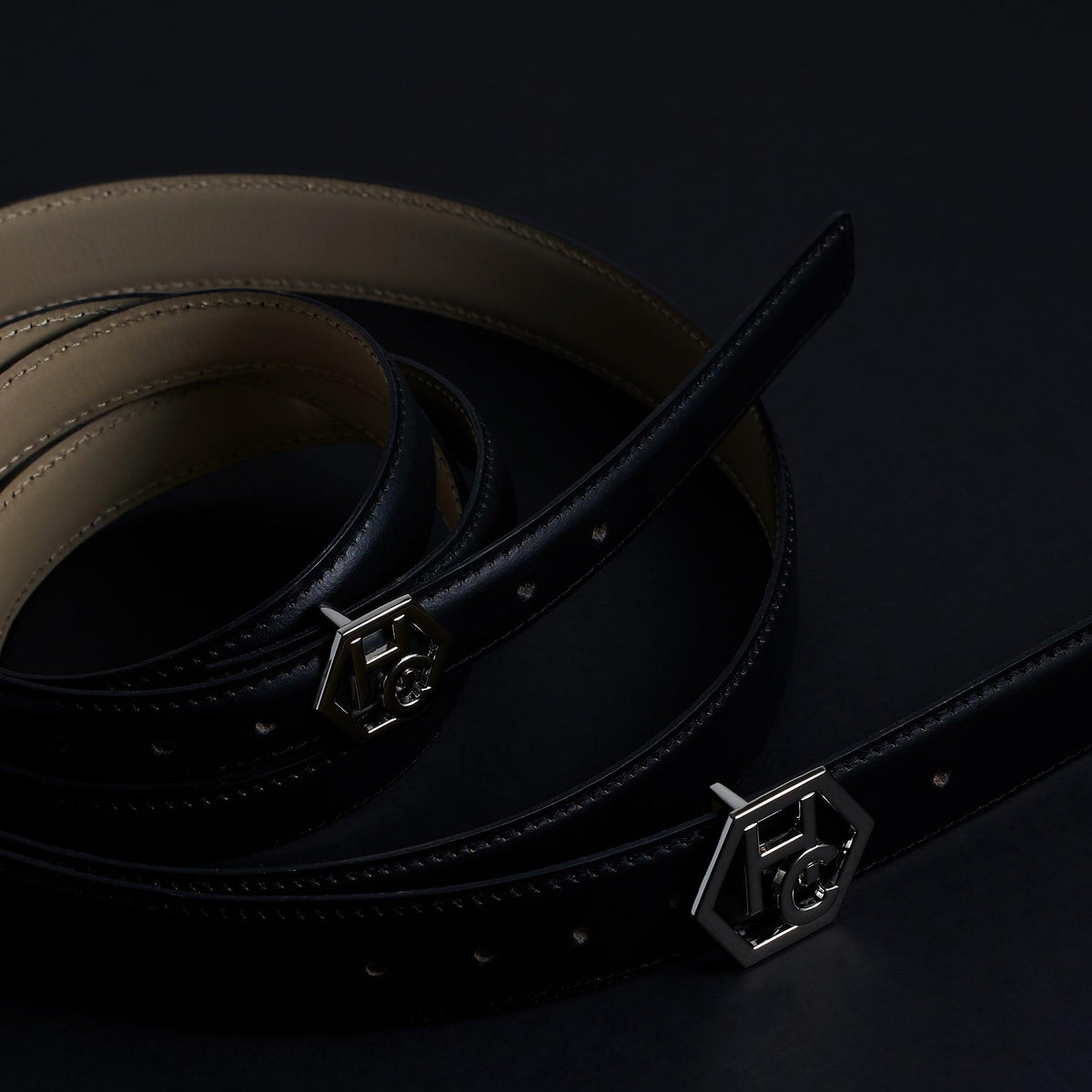 Side view on women's reversible design leather belt - black - Hedonist Chicago - close-up view (1", reversible with ivory)