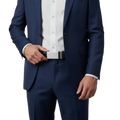 Person wearing a black leather belt with a blurred indoor background