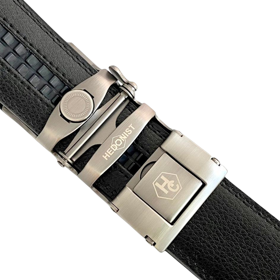 Black leather ratchet belt with long gunmetal rectangle buckle, hardware close-up