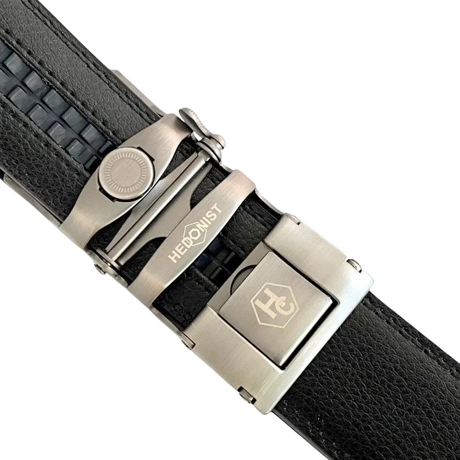 Black leather ratchet belt with long gunmetal rectangle buckle, hardware close-up