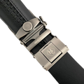 Black leather ratchet belt with oval metal buckle, hardware close-up