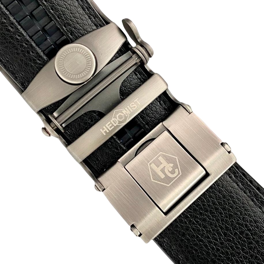 Black leather ratchet belt with silver buckle, hardware close-up