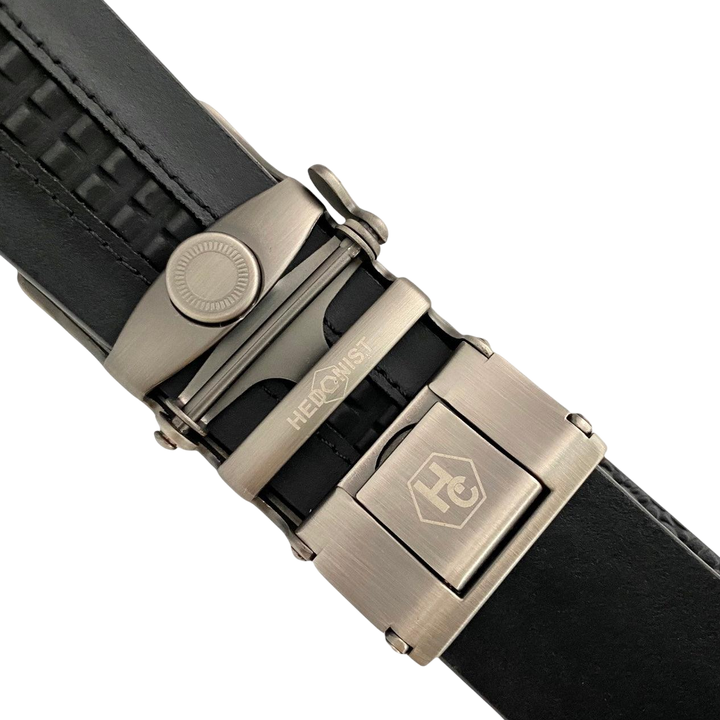 Black leather ratchet belt with brushed silver plate buckle, hardware close-up