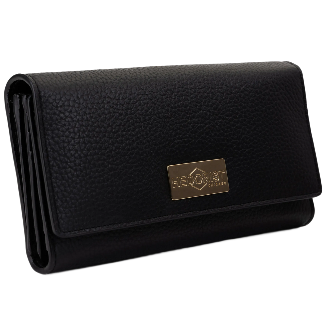 Black leather trifold wallet for women closed, gold-tone Hedonist Chicago plaque on front
