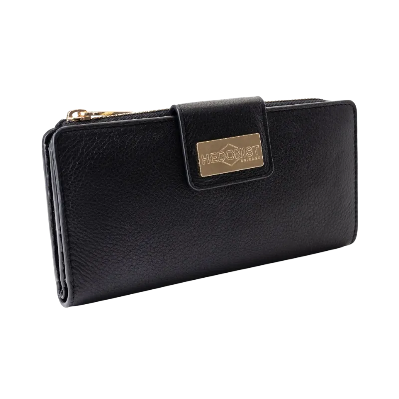 Black pebbled leather travel wallet for women closed, front view with card slot edge visible