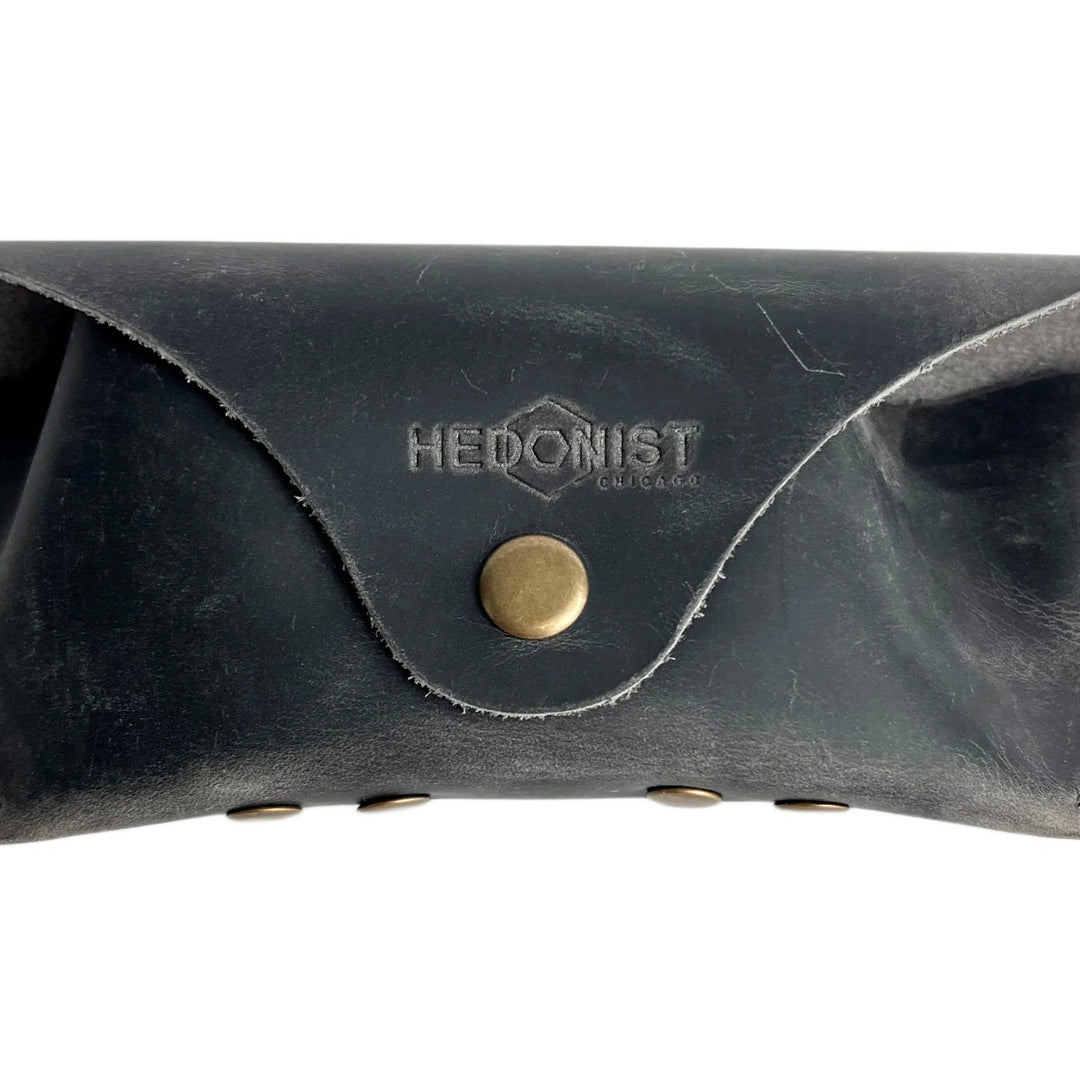 Soft Leather Eye Glasses Case in Black Washed, closed, front view showing weathered grain and embossed Hedonist logo