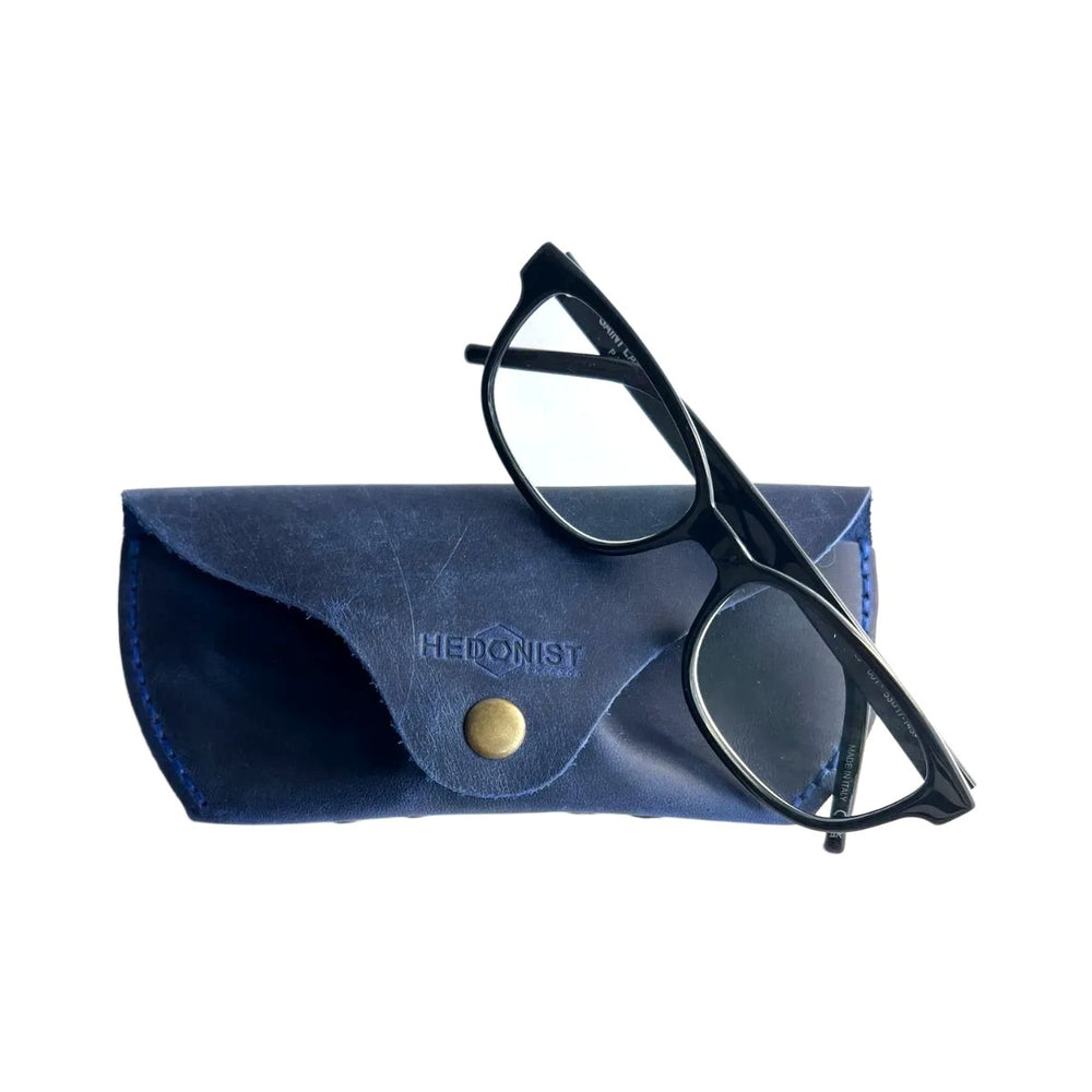 Soft Leather Eye Glasses Case in Navy Blue with black-framed eyeglasses resting on top