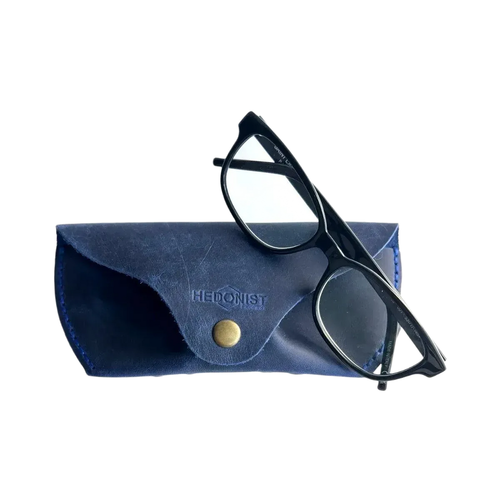 Soft Leather Eye Glasses Case in Navy Blue with black-framed eyeglasses resting on top