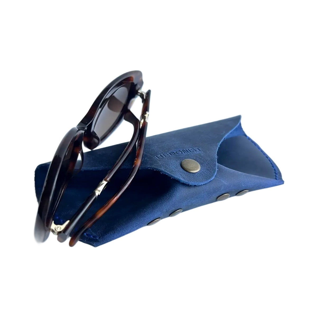 Soft Leather Eye Glasses Case in Navy Blue with tortoiseshell sunglasses resting on top