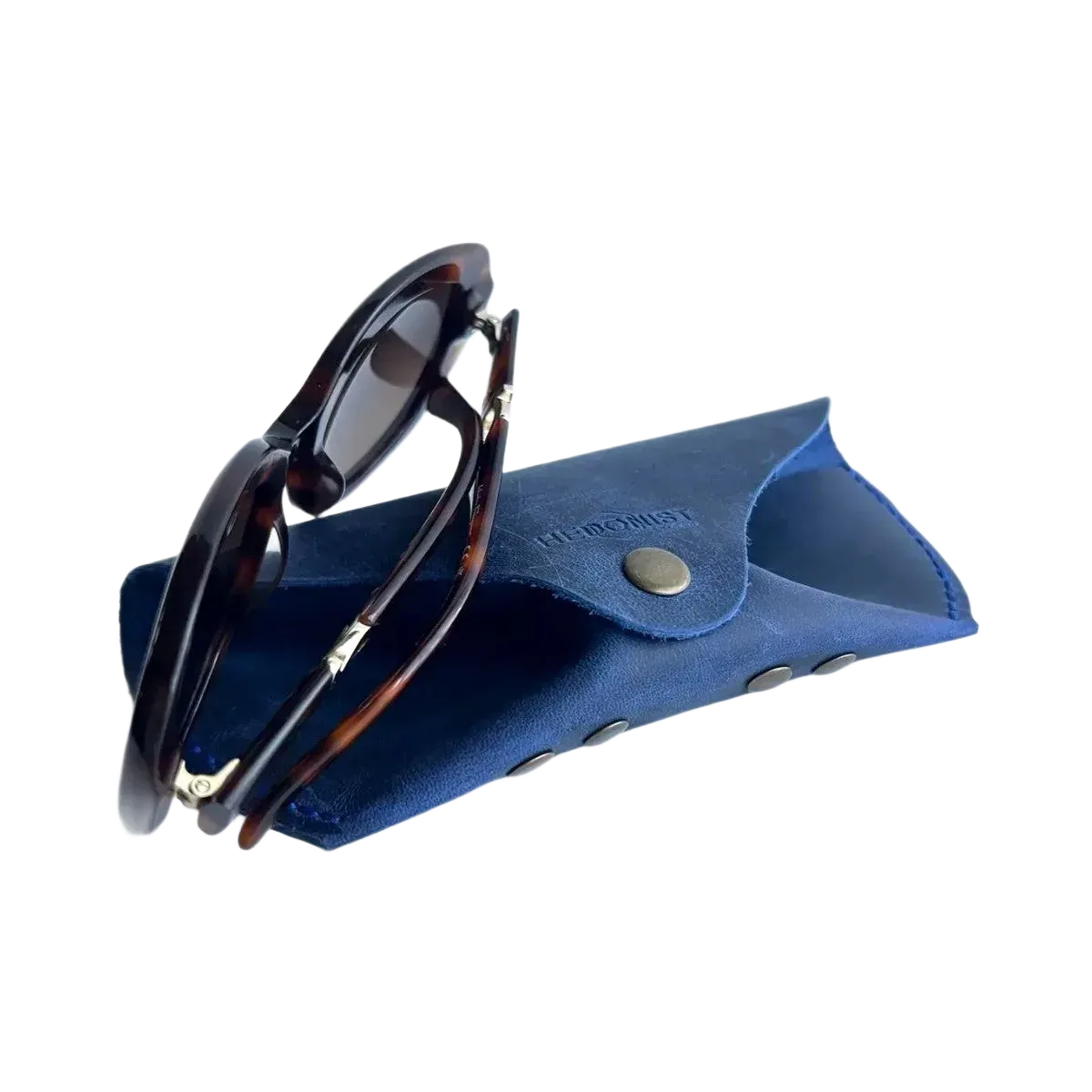 Soft Leather Eye Glasses Case in Navy Blue with tortoiseshell sunglasses resting on top