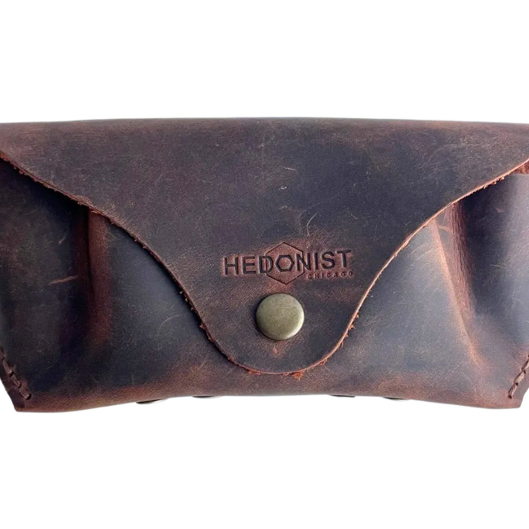 Soft Leather Eye Glasses Case in Brown, closed, front view with embossed Hedonist logo and snap closure