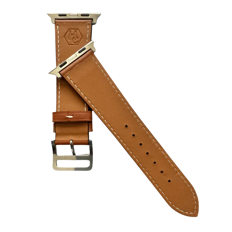 Brown leather Apple Watch band, texture and buckle detail close-up