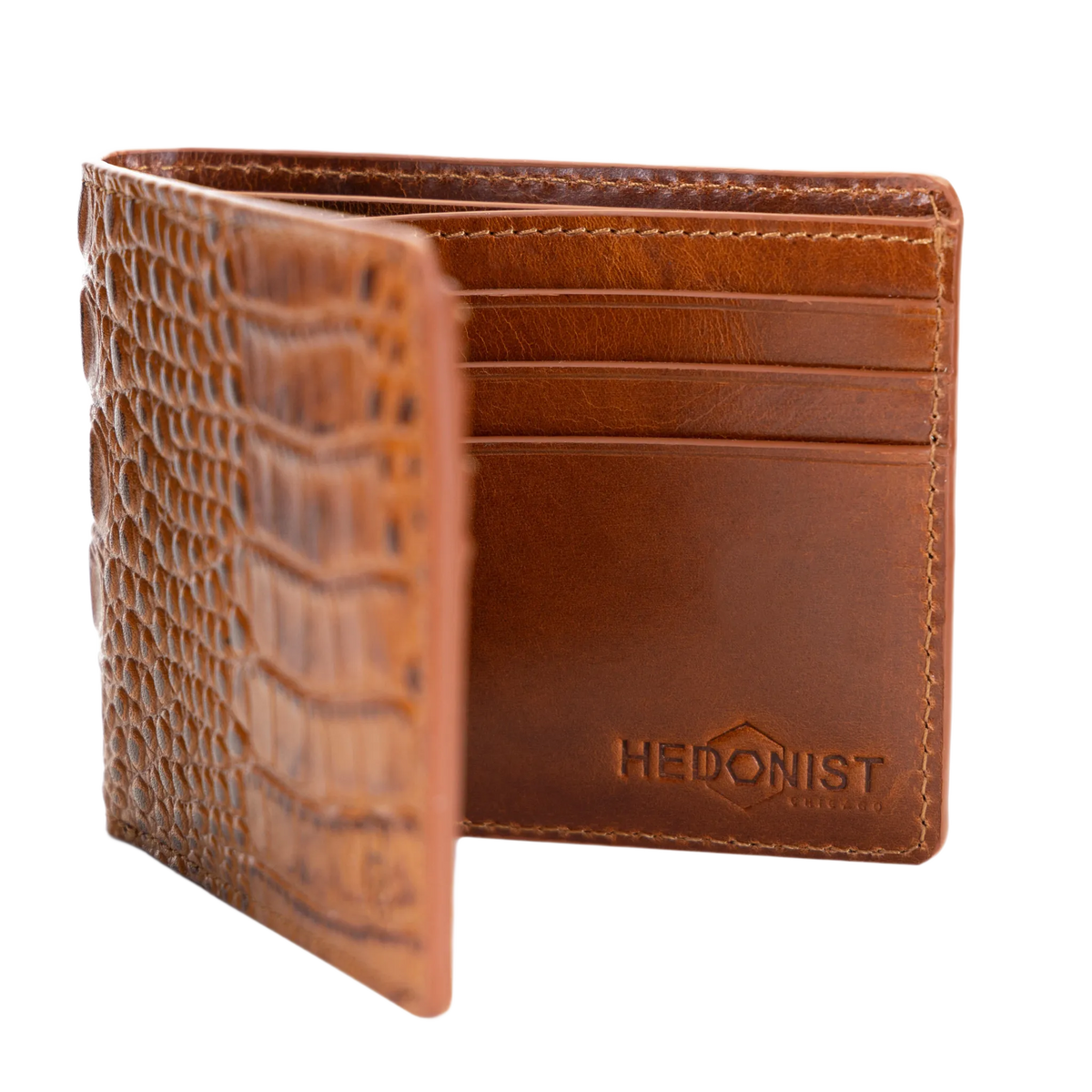 A brown leather bifold wallet with an embossed crocodile pattern on the front cover, shown open to reveal card slots and an embossed 'HEDONIST CHICAGO' logo on the inside back panel, set against a plain white background.