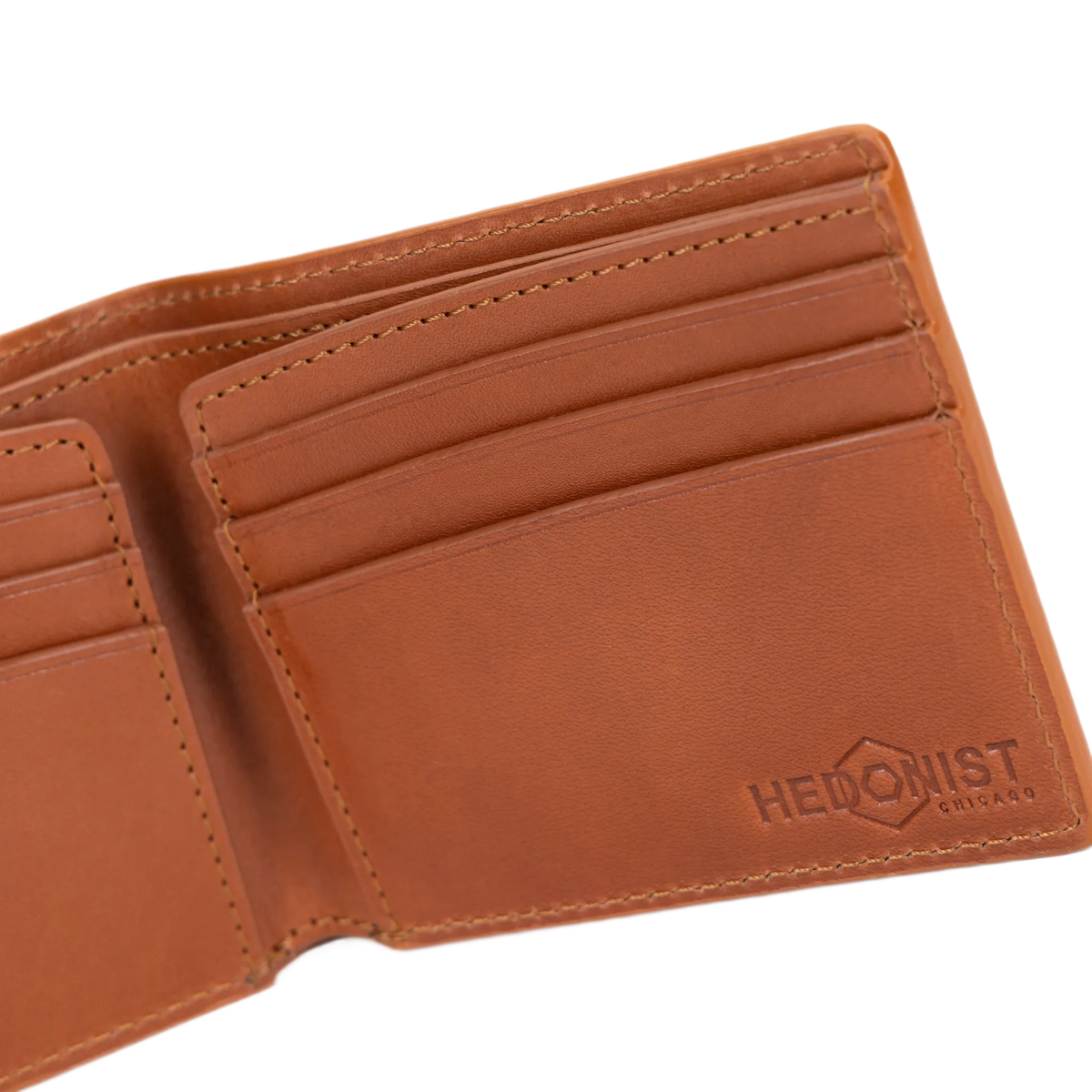Close-up of the embossed brand logo on brown croco leather bifold wallet pocket flap