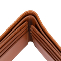 Close-up of the corner of a brown leather wallet showing the interior card slots and stitching against a white background.
