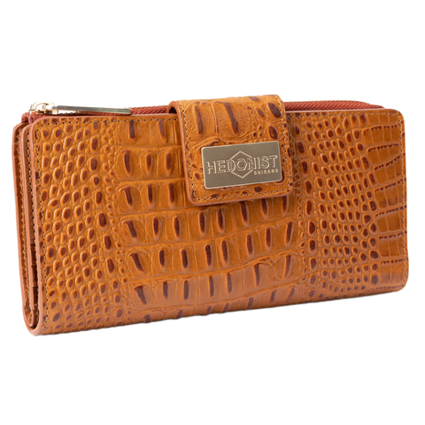 Large brown embossed leather travel wallet closed, front flap with gold-tone Hedonist Chicago plaque