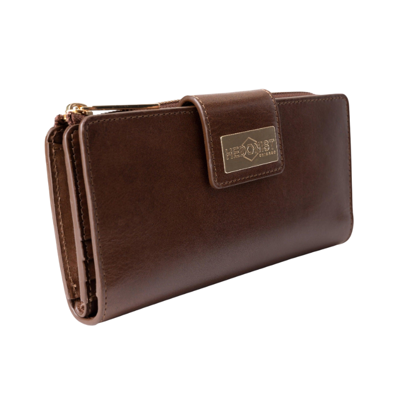 Brown leather travel wallet closed, front view with gold-tone Hedonist Chicago plaque