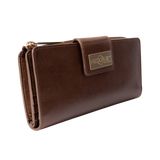 Brown leather travel wallet closed, front view with gold-tone Hedonist Chicago plaque