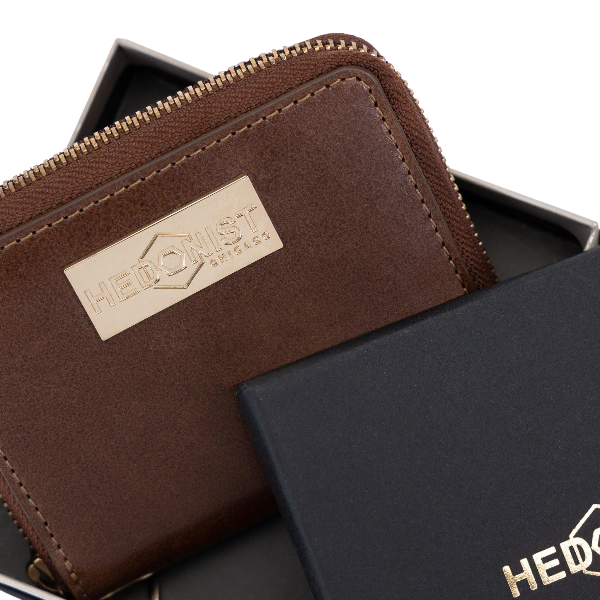 Small brown leather zip-around wallet for women, presented as a gift