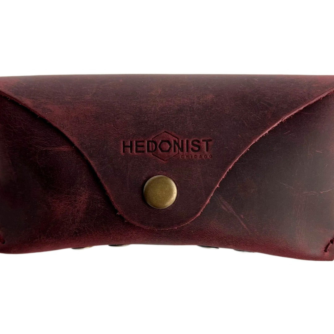 Soft Leather Eye Glasses Case in Burgundy, closed, front view with embossed Hedonist logo and snap closure