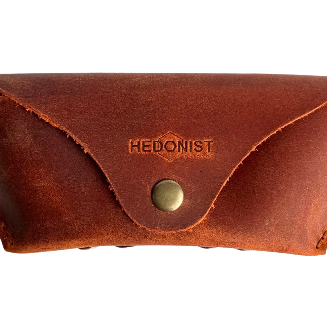 Soft Leather Eye Glasses Case in Cognac, closed, front view with embossed Hedonist logo and snap closure